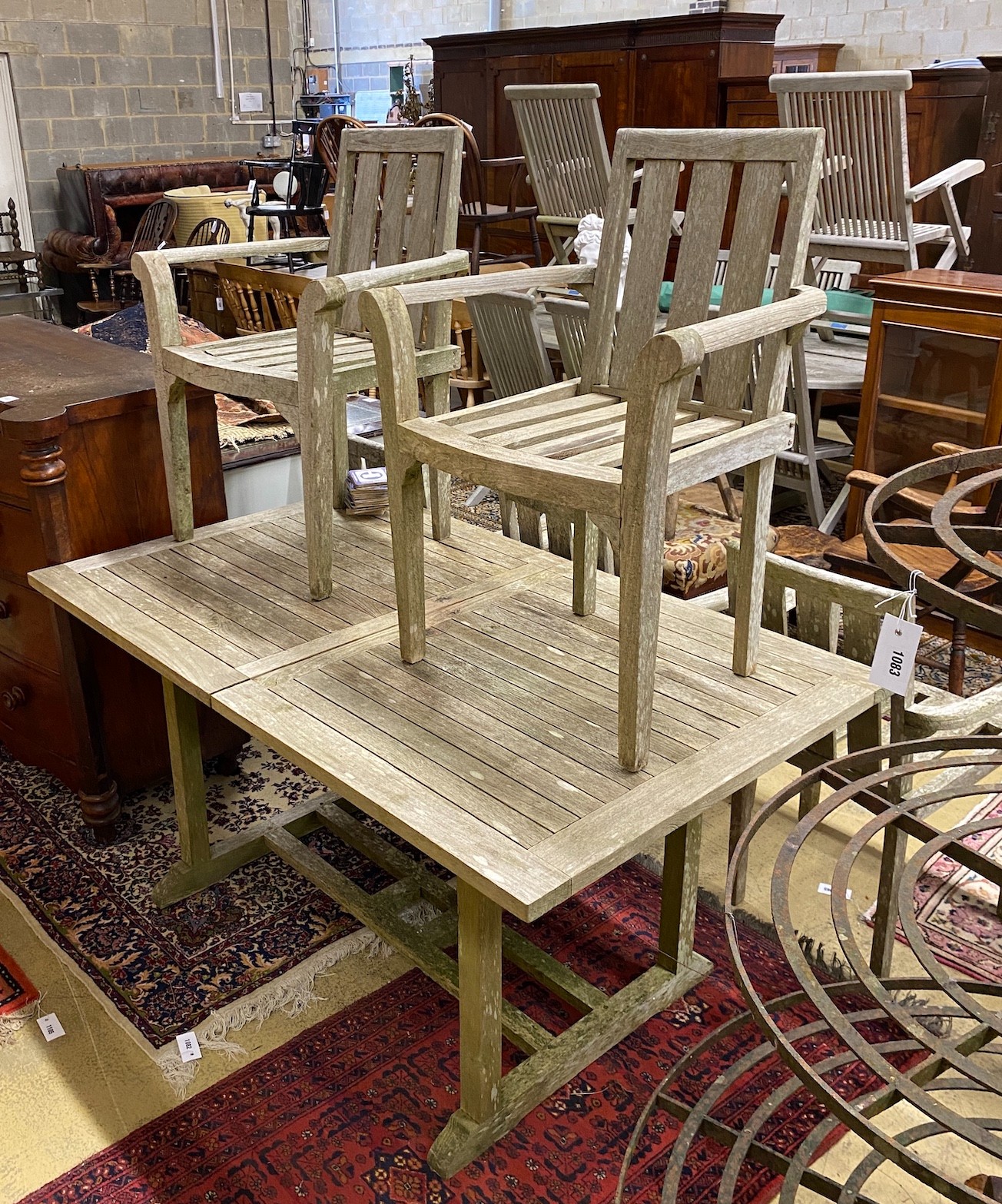 A weathered teak extending table, length 150cm, 90cm unextended and six teak chairs